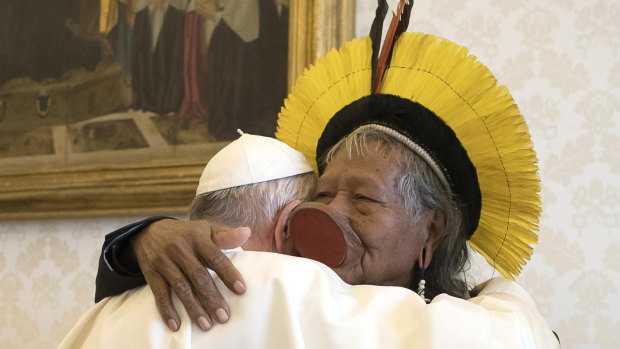 Pope Francis, left, embraces Chief Raoni Metuktire of the Kayapo Tribe in the Vatican on Monday. Raoni is travelling with a Xingu delegation to raise awareness of the threat to Amazon indigenous reserves.