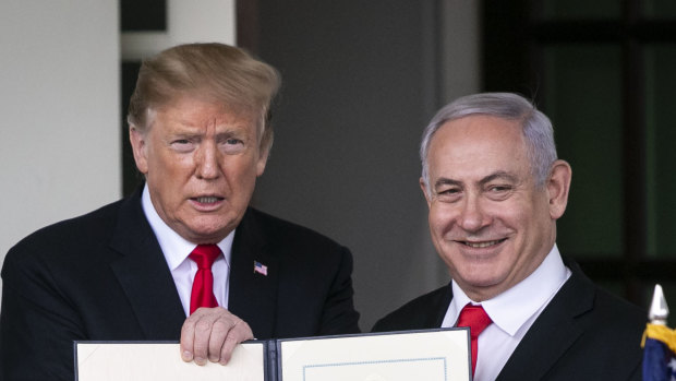 US President Donald Trump, left, and Benjamin Netanyahu, Israel's PM hold up a signed proclamation after a meeting at the White House in Washington, DC. 