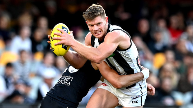 Run and carry: Magpie Taylor Adams attempts to power through a tackle during the win over the Blues.