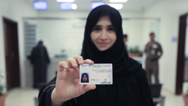 Tahani Aldosemani, a university assistant professor, displays her brand new driver's licence at the General Department of Traffic. 