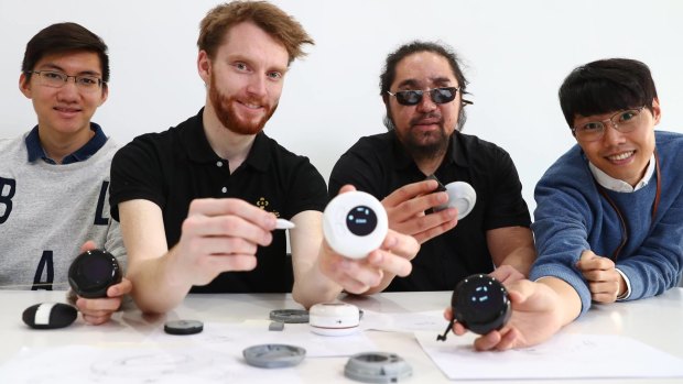 Co-founders of Brisbane start-up OSeyeris Jake Dean (second from left) and Yuma Decaux (third from left) with their digital tape measure for the visually-impaired.