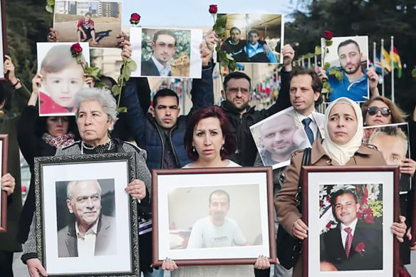 Syrian activist Noura Ghazi (centre) with a picture of her husband Bassel Khartabil at a ‘‘Families for Freedom’’ demonstration outside the UN’s office in Geneva in February 2017. 