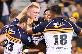 Brumbies players celebrate a winning try by Charlie Cale against the Blues.