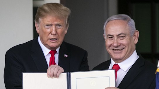 US President Donald Trump, left, and Benjamin Netanyahu, Israel's PM hold up a signed proclamation after a meeting at the White House in Washington, DC. 