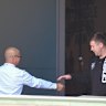 Former CFMEU NSW assistant secretary Michael Greenfield (right) and secretary Darren Greenfield (left, obscured) at union headquarters with an employer they received $5000 bribes from.