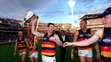 Peter Caven holds the trophy after Adelaide defeated North Melbourne.