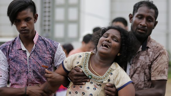 Relatives of a blast victim grieve outside a morgue in Colombo, Sri Lanka.