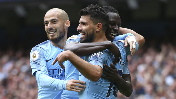 Fit and firing: Manchester City's Sergio Aguero (centre) celebrates scoring his side's third goal of the game.
