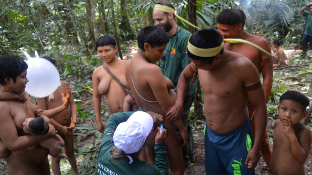 A Korubo woman is vaccinated by a Funai member during an expedition to the Javari Valley, in Brazil, last year. 