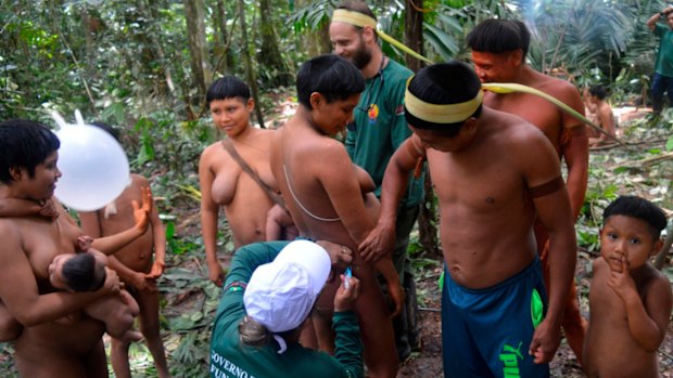 A Korubo woman is vaccinated by a Funai member during an expedition to the Javari Valley, in Brazil, last year. 