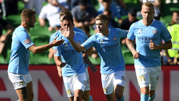 Spot on: Riley McGree of City (second from right) reacts after scoring a penalty goal to level proceedings against Newcastle at AAMI Park in Melbourne.