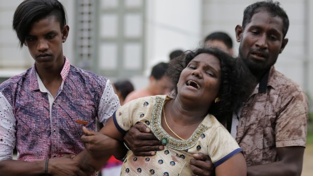 Relatives of a blast victim grieve outside a morgue in Colombo, Sri Lanka.