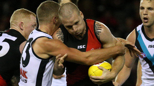 Jake Stringer of the Bombers is tackled by Dan Houston of the Power.