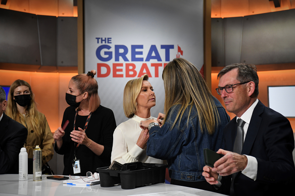 Panellists get some work done during debate rehearsals at Channel Nine, Sydney over the weekend.
