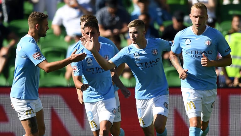 Spot on: Riley McGree of City (second from right) reacts after scoring a penalty goal to level proceedings against Newcastle at AAMI Park in Melbourne.