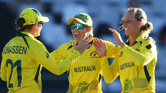 Player of the match Ashleigh Gardner (right) celebrates Australia’s dramatic semi-final victory with Jess Jonassen and Meg Lanning.
