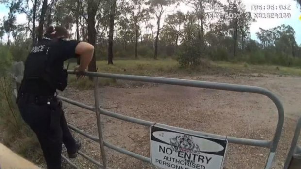 In this evidence tabled in the inquest into the Wieambilla shootings of December 2022, a police officer can be seen at the gate to the Trains’ property.