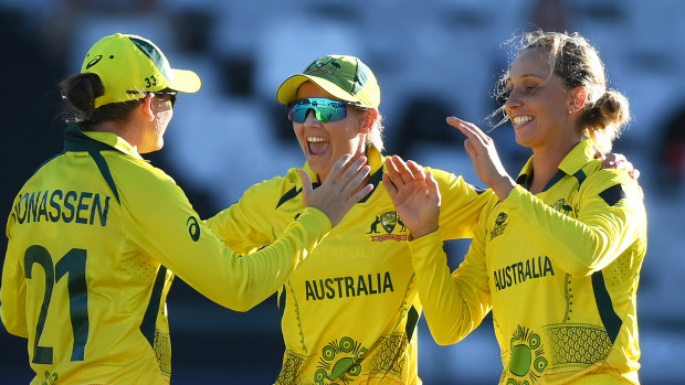 Player of the match Ashleigh Gardner (right) celebrates Australia’s dramatic semi-final victory with Jess Jonassen and Meg Lanning.