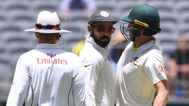 Combustible Kohli: The Australia and India captains engage in some on-field niceties in Perth. 