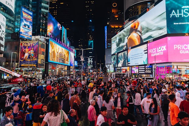 Times Square at night with huge crowds and bright lights