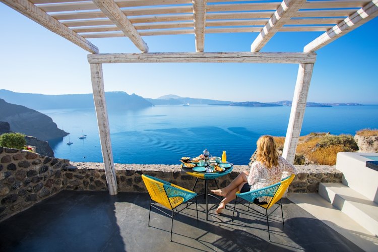 Woman enjoying breakfast with beautiful view over Santorini
iStock image for Traveller. Reuse permitted.
Greek breakfast, in Greece (Greek Islands)
