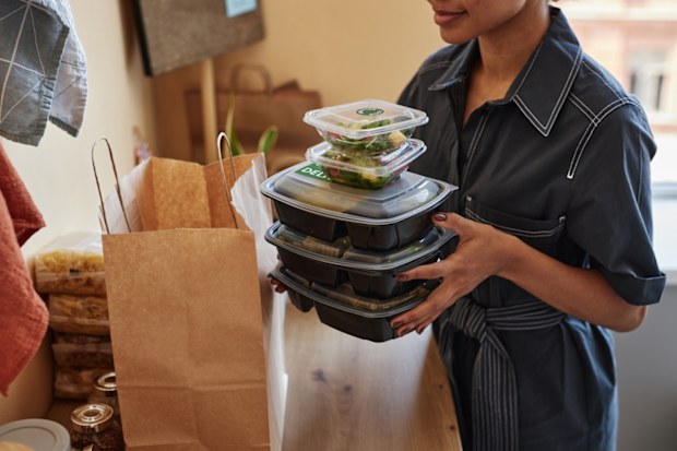 woman unpacking food delivery order at home