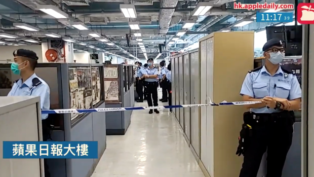 Hong Kong police cordon off the Apple Daily newsroom on Monday. 