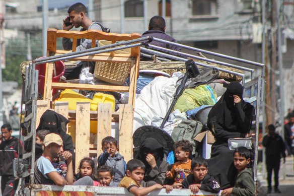 Palestinians flee following Israeli army orders to evacuate the eastern side of Rafah, Gaza.
