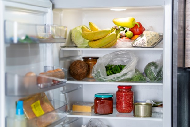 An Open Refrigerator Filled With Fresh Fruits And Vegetables