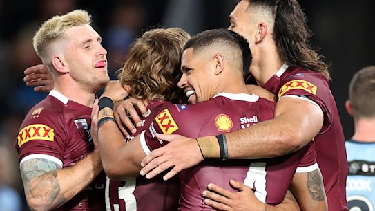 The Maroons celebrate Valentine Holmes’ try.