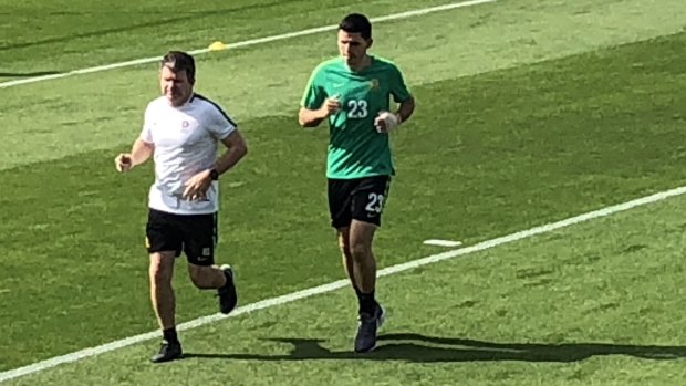 Battling: Tom Rogic trains with a bandage on his broken hand in Dubai on Tuesday.
