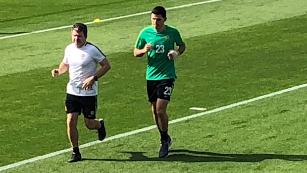 Battling: Tom Rogic trains with a bandage on his broken hand in Dubai on Tuesday.