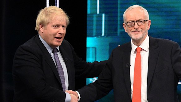 The two leaders shake hands after an audience member urged them to tone down the divisive rhetoric.