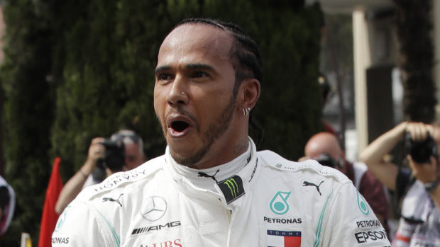 Frontrunner: Lewis Hamilton celebrates after securing pole position in Monaco.