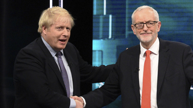 The two leaders shake hands after an audience member urged them to tone down the divisive rhetoric.