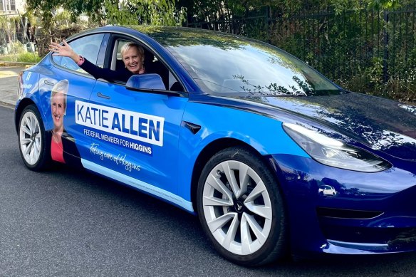Katie Allen in her Tesla, specially branded for the campaign.
