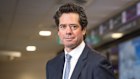 A portrait of Tabcorp CEO Gillon McLachlan standing in front of Tabcorp betting machines ahead of his move to pull all betting machines from pubs.