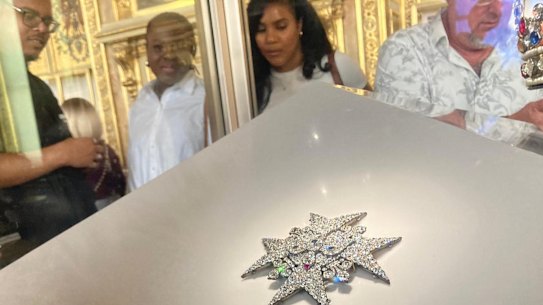 Visitors look at fine jewellery in the Louvre Museum in September.