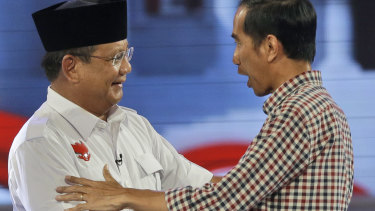 Joko Widodo, now Indonesia's President, shakes hands with his then opponent Prabowo after a 2014 debate.