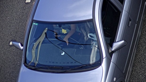 A driver texts on a high-speed road,