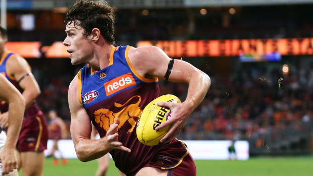 Running free: Lion Lachie Neale was 'pounded' by Port Adelaide players, says coach Chris Fagan.
