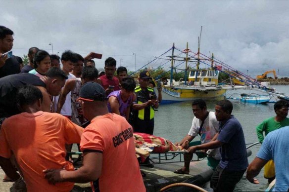 A body is returned to shore after an incident in which three were killed in waters off Scarborough Shoal.