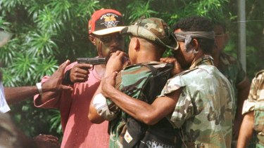 Corporal Allen, personal bodyguard of the sacked military commander, Brigadier-General Singirok, pulls his pistol on one of four soldiers who arrived at Murray Barracks in Port Moresby yesterday morning reportedly asking for food. 