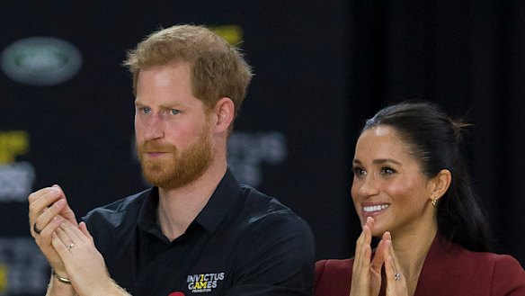 Britain's Prince Harry, the Duke of Sussex and his wife Meghan, the Duchess of Sussex are seen during the medal presentation following the Wheelchair Basketball Final.