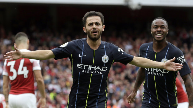 Manchester City's Bernardo Silva celebrates with Raheem Sterling after scoring his side's second goal against Arsenal at the Emirates on Sunday.