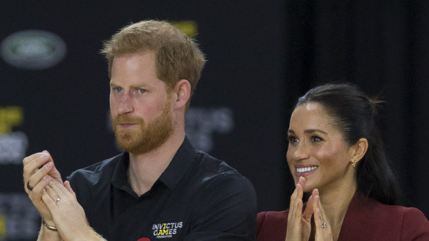 Britain's Prince Harry, the Duke of Sussex and his wife Meghan, the Duchess of Sussex are seen during the medal presentation following the Wheelchair Basketball Final.