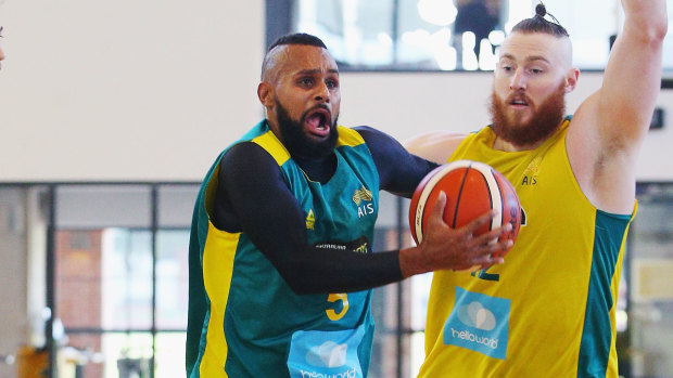 Driving hard: NBA stars Patty Mills and Aron Baynes in Boomers practice.