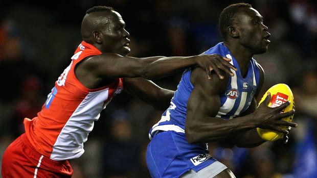 Match-up: Sydney's Aliir Aliir (left) competes with Majak Daw of the Kangaroos.