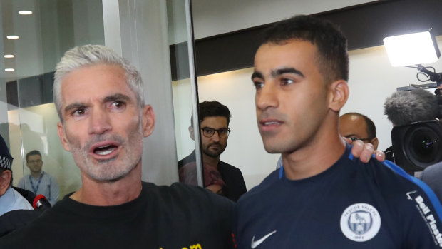 Former Socceroo Craig Foster with refugee footballer Hakeem al-Araibi at Melbourne International Airport on Tuesday,