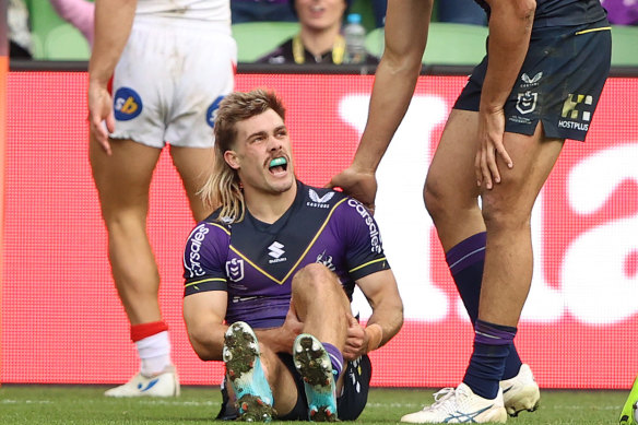 Ryan Papenhuyzen clutches his left hamstring during the Storm’s win over the Dragons.